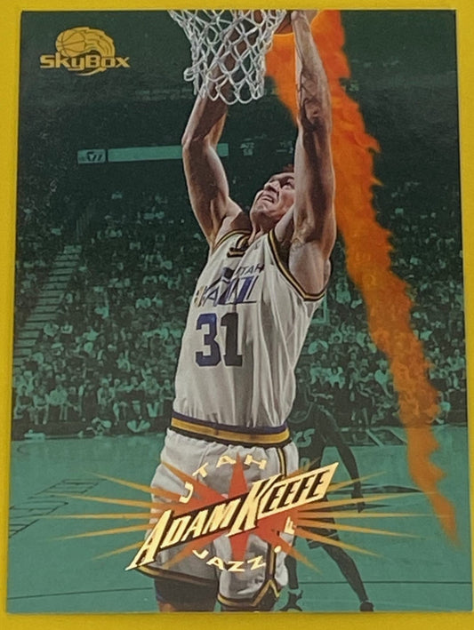 A collectible sports card featuring Adam Keefe from the Utah Jazz in basketball attire. 
