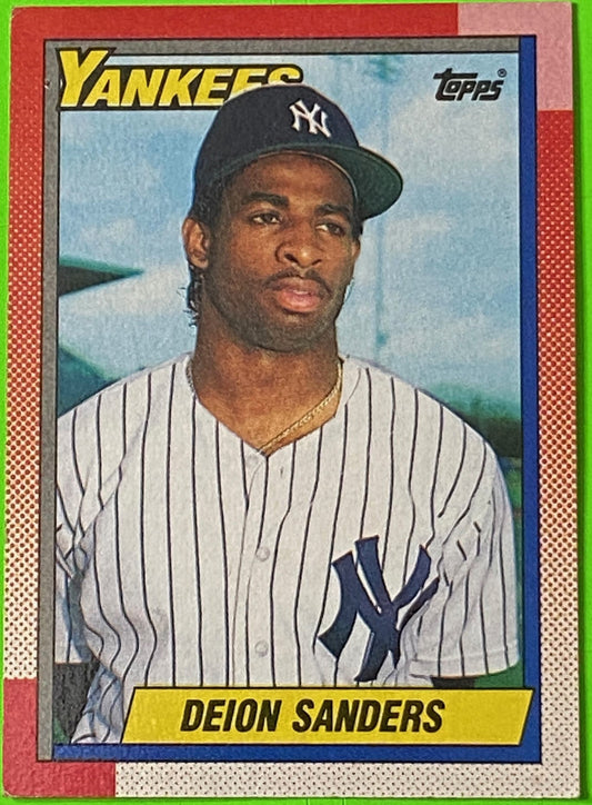 A collectible baseball card featuring Deion Sanders of the New York Yankees. The card has the Topps logo at the top and displays the player in a Yankees uniform with the team's name upper left.